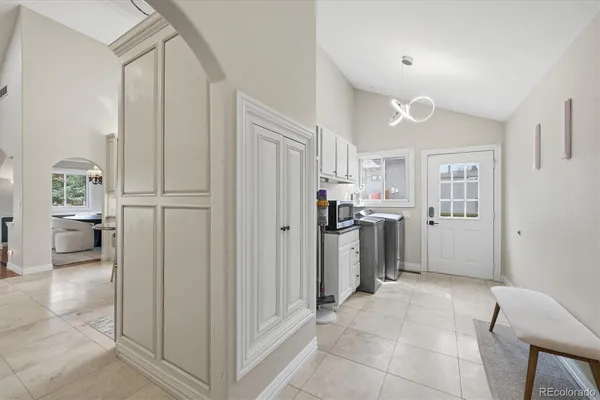 a view of a kitchen with furniture and an entryway