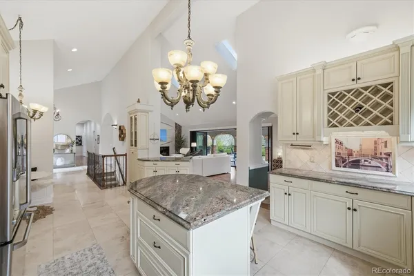 a kitchen with stainless steel appliances granite countertop a sink a stove and a refrigerator
