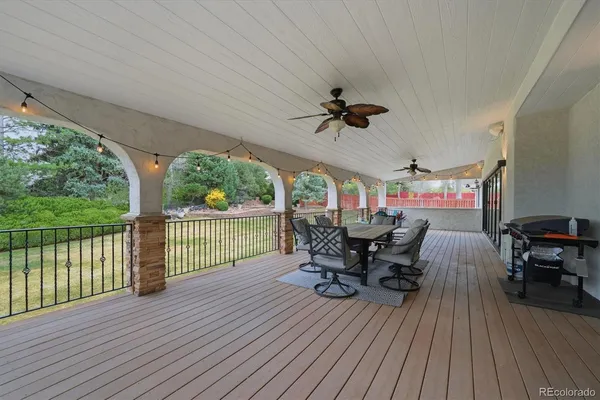 a view of a patio with table and chairs with wooden floor