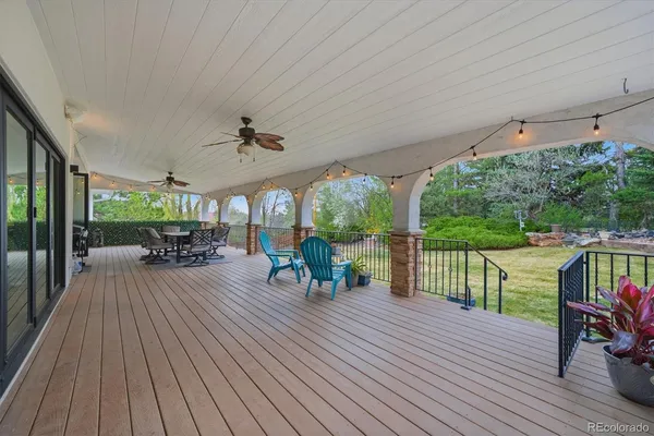 a view of a patio with lawn chairs floor to ceiling window with wooden floor