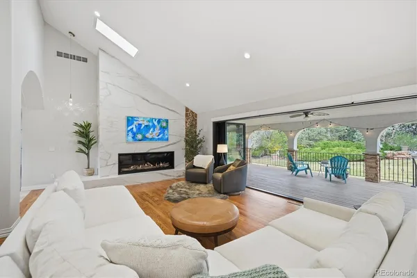 a living room with furniture large window and floor to ceiling window