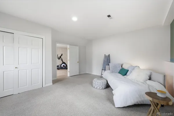 a bed room with a bed and a chair