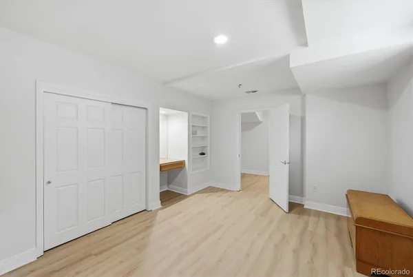 a view of empty room with wooden floor