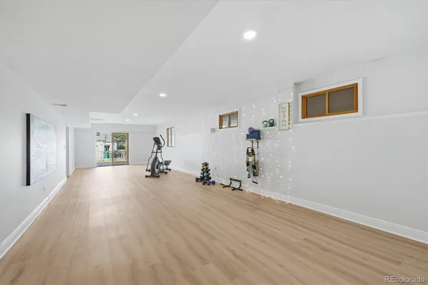 a view of a livingroom with wooden floor and a large window