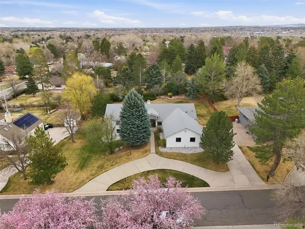 an aerial view of a house with a yard