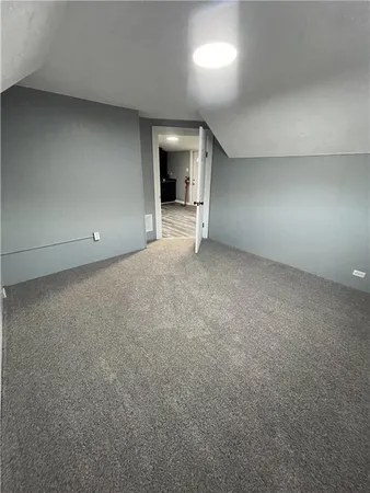 a view of an empty room with a fireplace