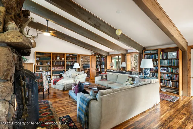 a living room with furniture a window and a chandelier