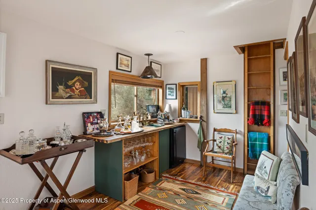 a living room with furniture ceiling fan and a large window