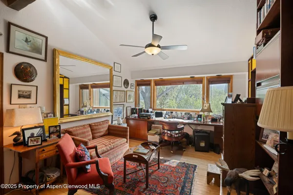 a spacious bedroom with a large window and a bed