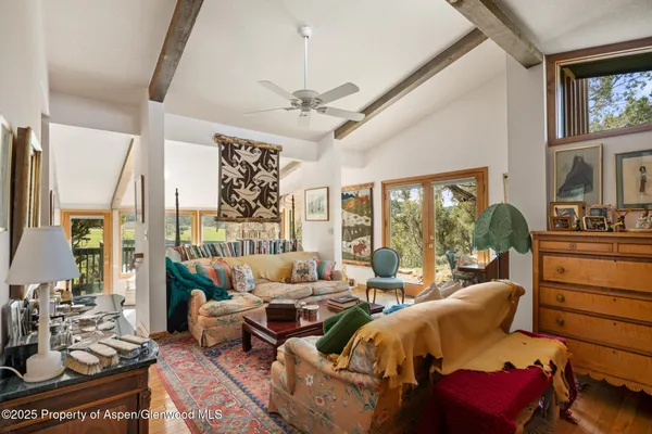 a room with furniture a rug and a large window