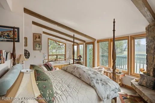 a bedroom with two beds and a chair