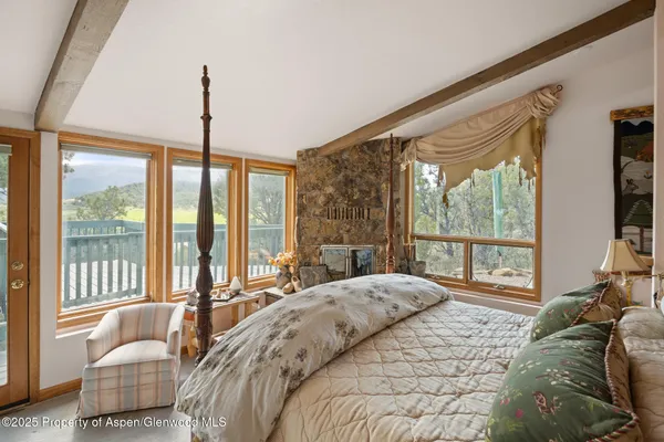 a bedroom with a bed couch and window