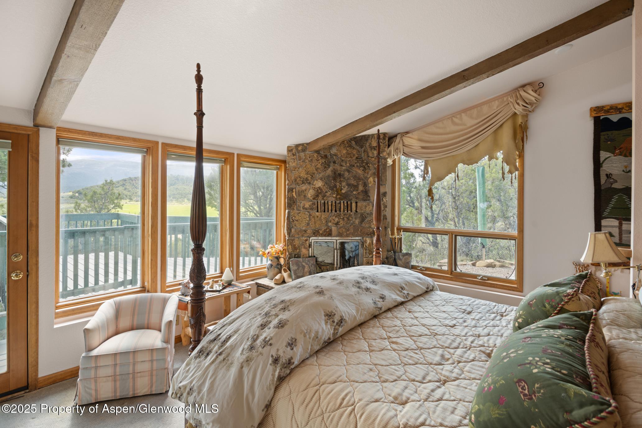 4440 County Road 342 Silt, CO 81652 - Photo 22 of 62 a bed room with a bed and a couch next to a window