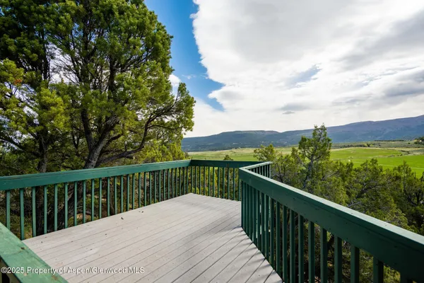 a bathroom with a granite countertop sink and a large mirror