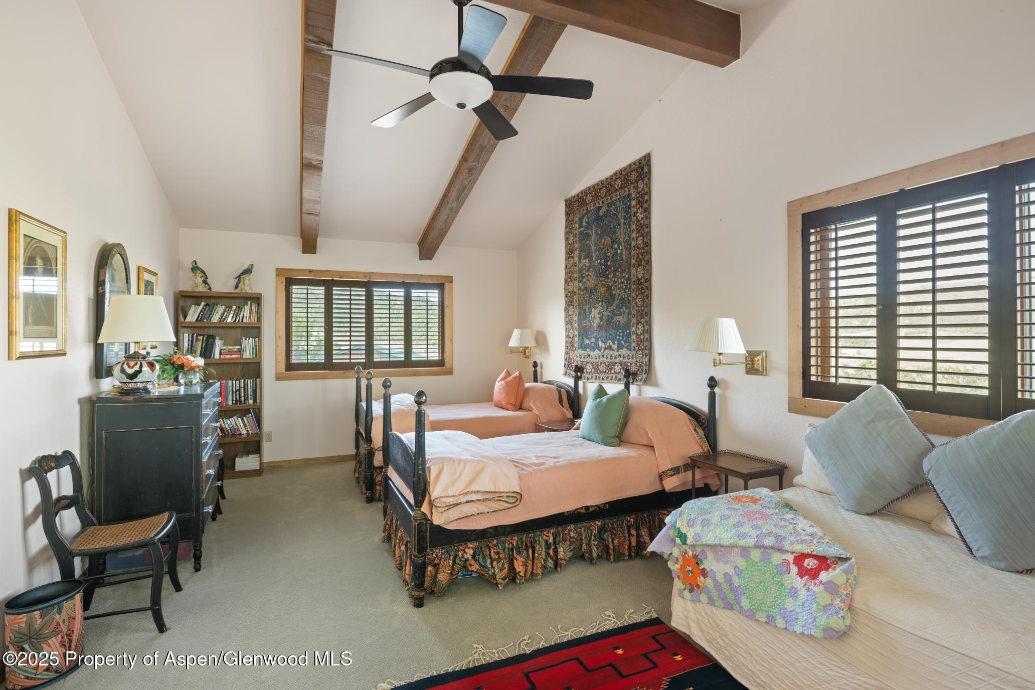 4440 County Road 342 Silt, CO 81652 - Photo 26 of 62 a bedroom with two beds and a chair