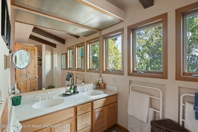 a view of a patio with couches table and chairs with wooden fence and plants