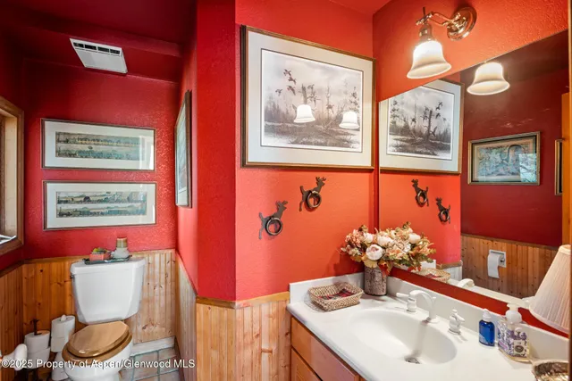 a view of patio with table and chairs and potted plants with wooden floor and fence