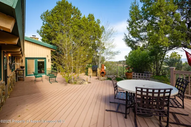 a view of a patio with table and chairs and potted plants