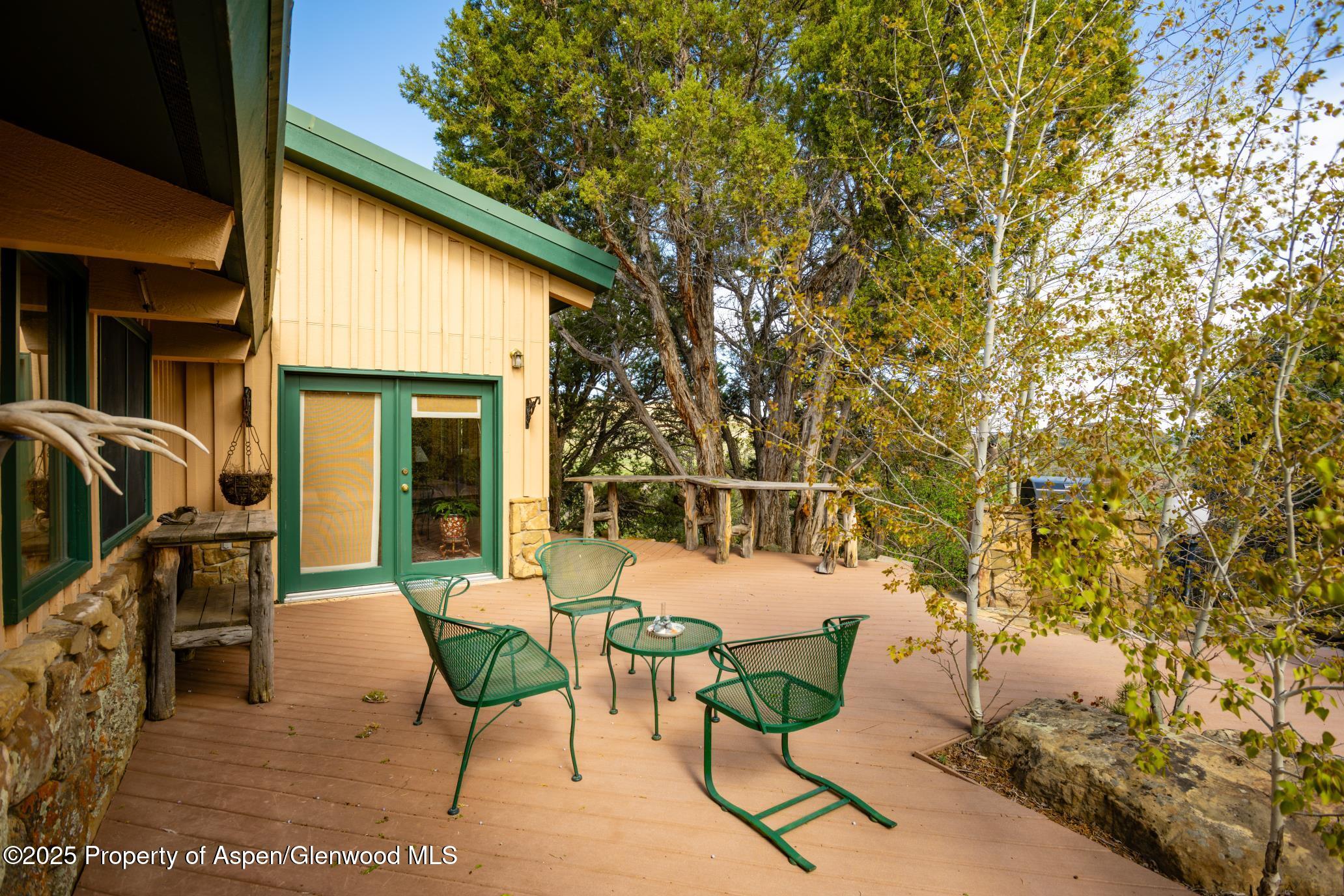 4440 County Road 342 Silt, CO 81652 - Photo 34 of 62 a view of a patio with couches table and chairs with wooden fence and plants
