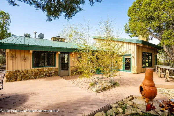 a view of a dining room with furniture a rug and wooden floor