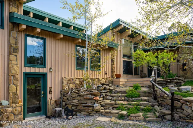 a view of a dining room with furniture wooden floor and chandelier
