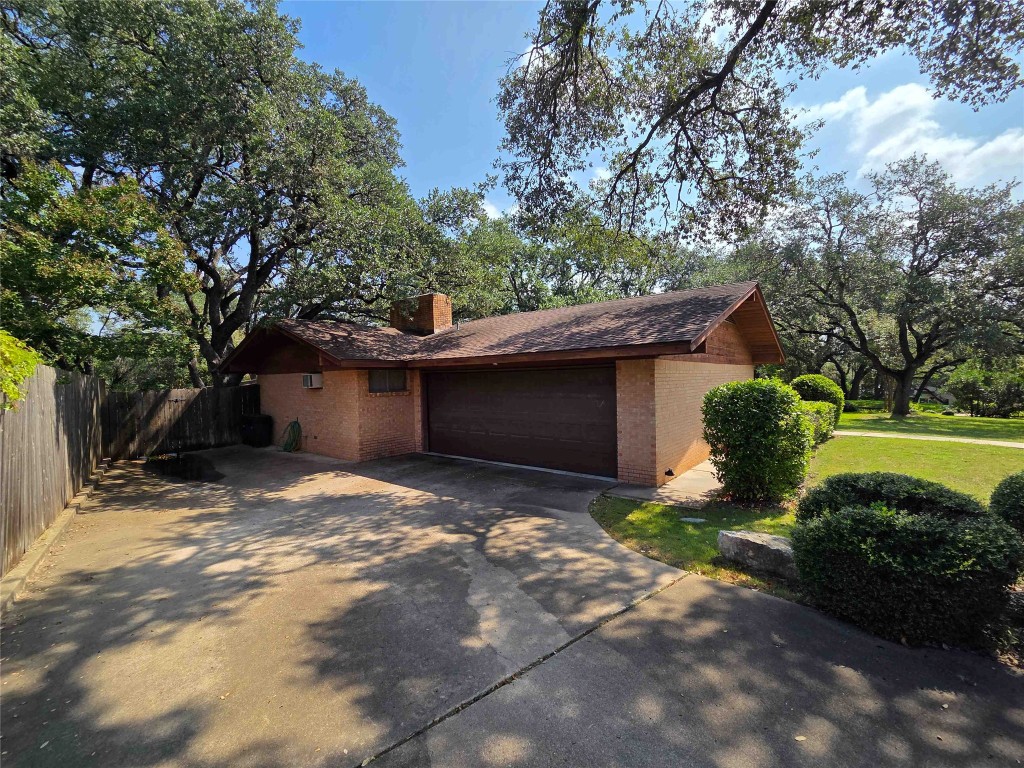 402 Honeycomb Ridge Austin, TX 78746 - Photo 13 of 40 a view of a house with backyard and a tree