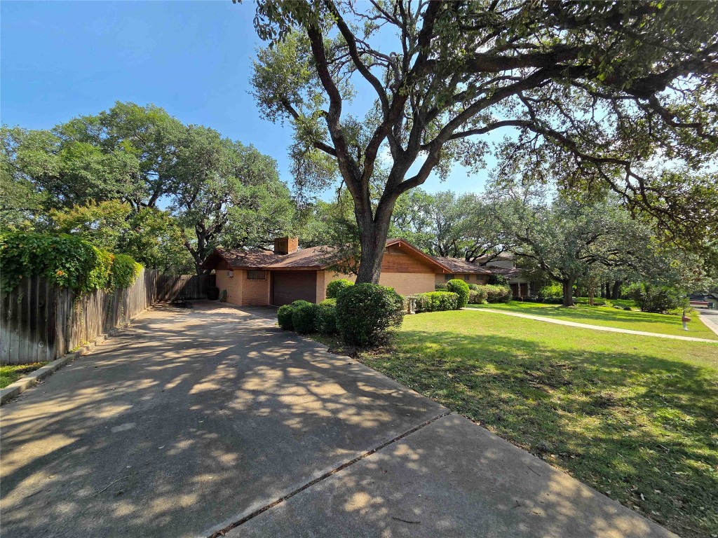 402 Honeycomb Ridge Austin, TX 78746 - Photo 14 of 40 a view of a garden with large trees