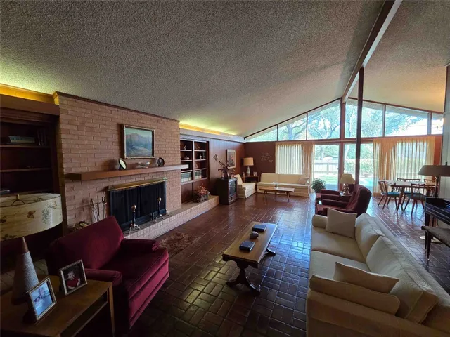 a living room with furniture fireplace and a large window