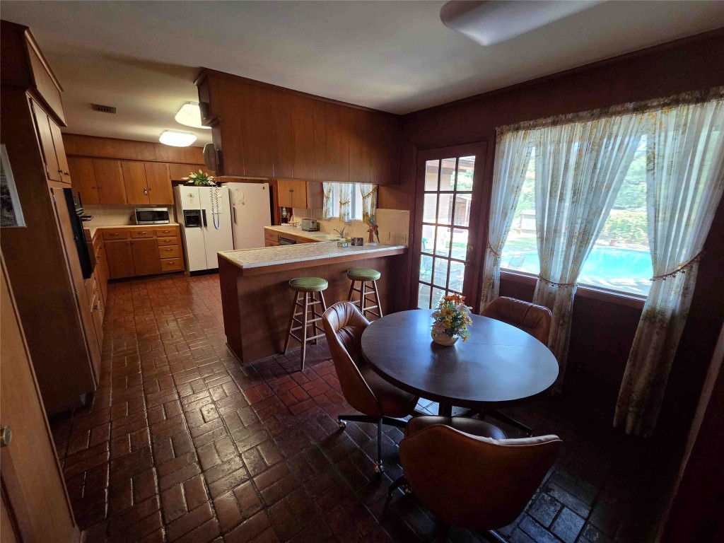 402 Honeycomb Ridge Austin, TX 78746 - Photo 23 of 40 a view of a dining room with furniture window and wooden floor