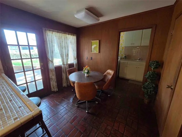 a dining room with furniture and wooden floor