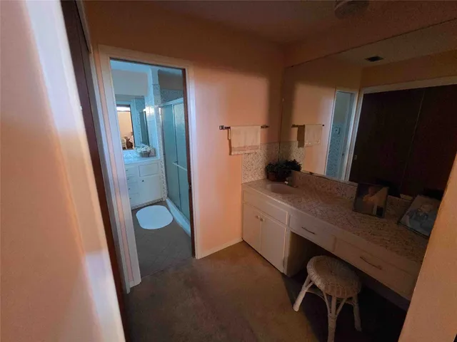 a bathroom with a granite countertop sink