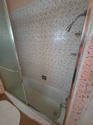 a bed sitting in a room next to a lamp