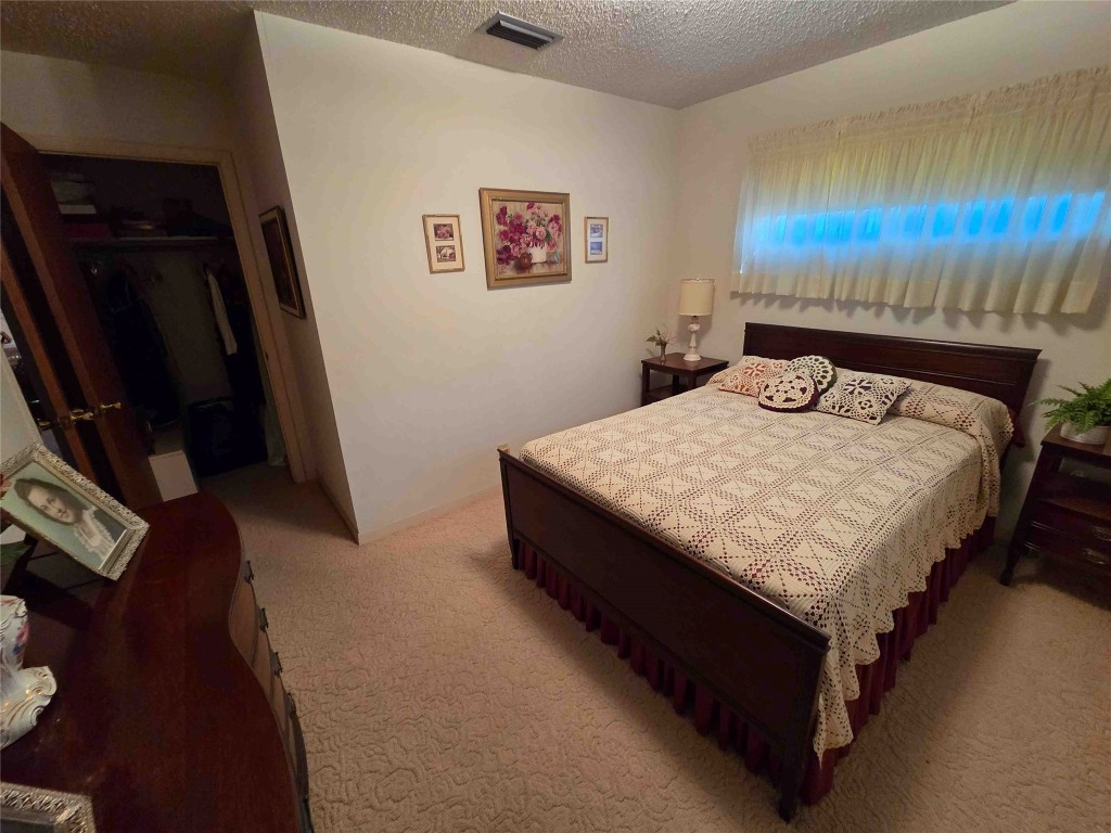 402 Honeycomb Ridge Austin, TX 78746 - Photo 33 of 40 a bed sitting in a bedroom next to a window