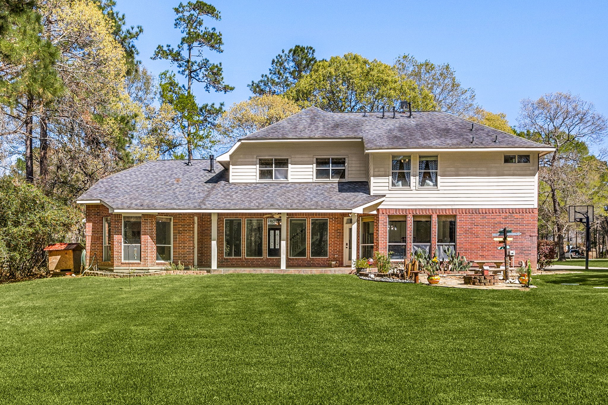 14419 Timbergreen Drive Magnolia, TX 77355 - Photo 30 of 43 Enjoy the expansive backyard with mature trees, covered patio, and plenty of space for outdoor living, entertaining, or play.