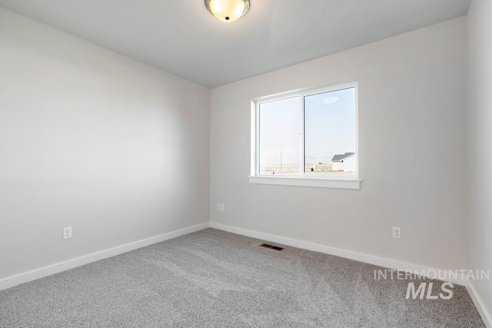 985 Twilight Street Weiser, ID 83672 - Photo 19 of 32 Spare room featuring baseboards and carpet floors