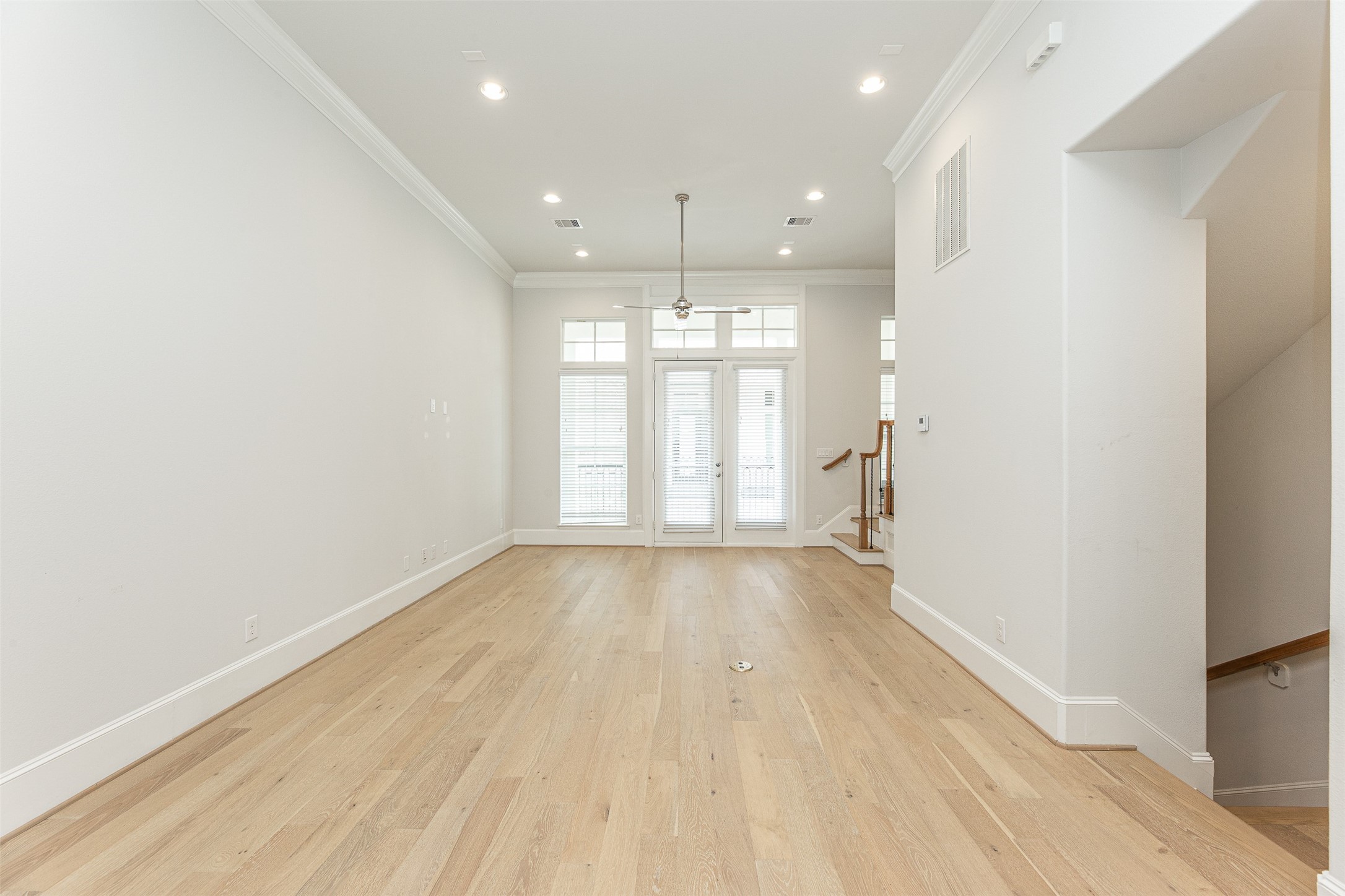 2028 Waterloo Station Road Houston, TX 77045 - Photo 11 of 34 an empty room with wooden floor and windows