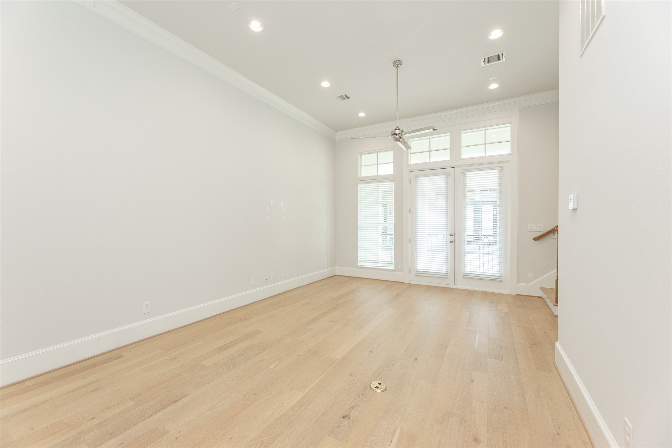 2028 Waterloo Station Road Houston, TX 77045 - Photo 12 of 34 an empty room with wooden floor and windows
