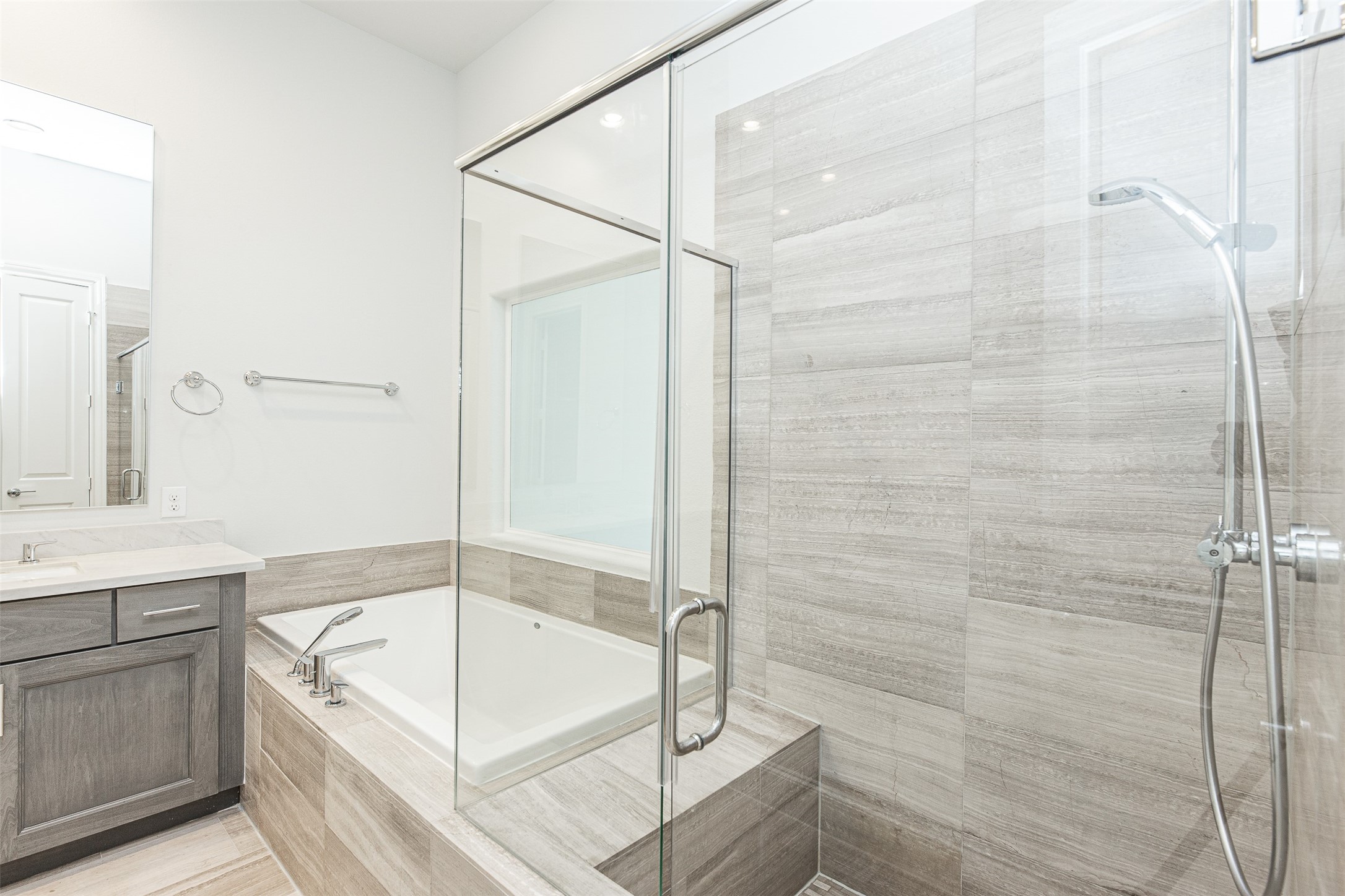 2028 Waterloo Station Road Houston, TX 77045 - Photo 29 of 34 a bathroom with a tub shower vanity and a sink