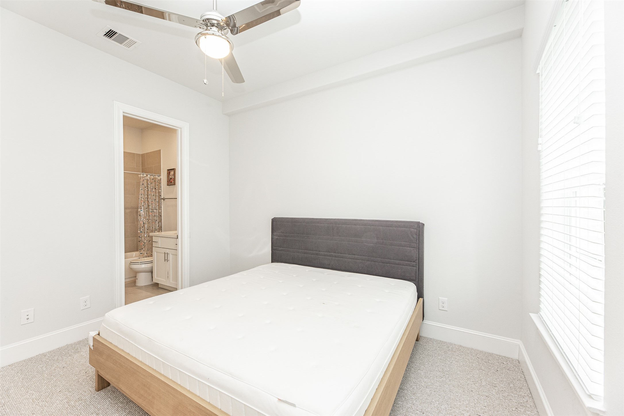 2028 Waterloo Station Road Houston, TX 77045 - Photo 7 of 34 a bedroom with a bed and a window