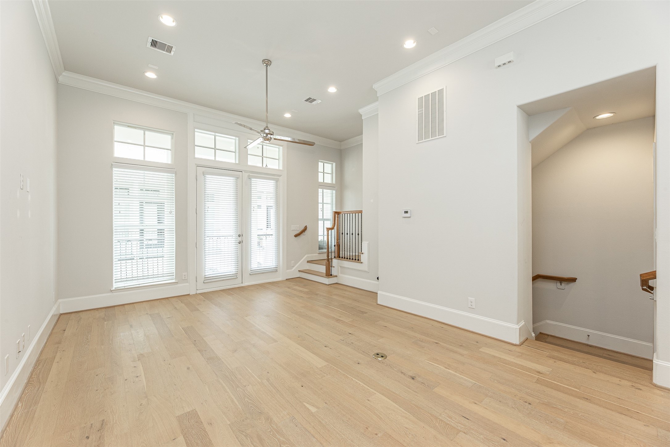 2028 Waterloo Station Road Houston, TX 77045 - Photo 10 of 34 a view of an empty room with a window and wooden floor