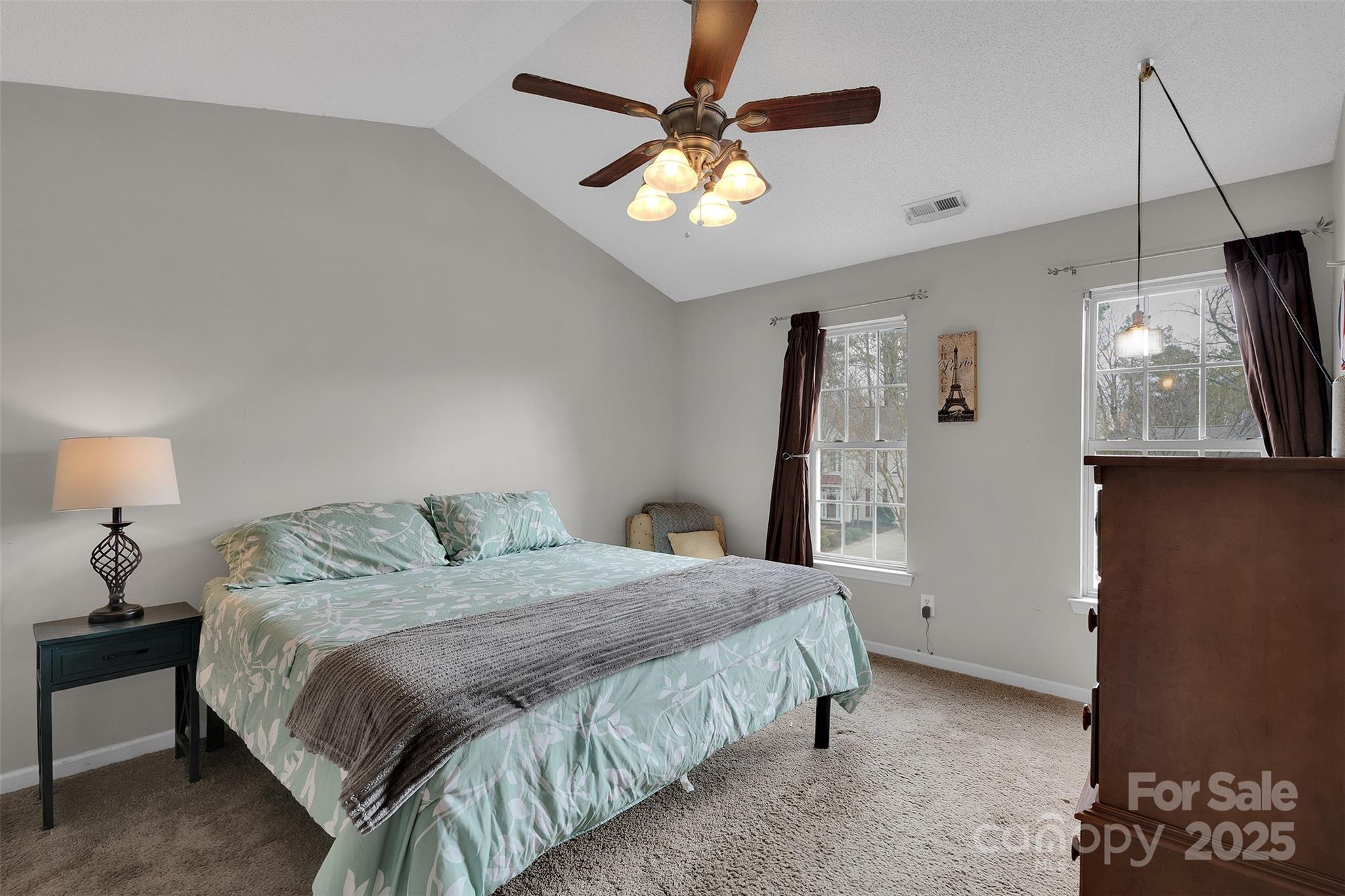3007 Wyntree Court Matthews, NC 28104 - Photo 28 of 44 a bedroom with a bed window and a chandelier