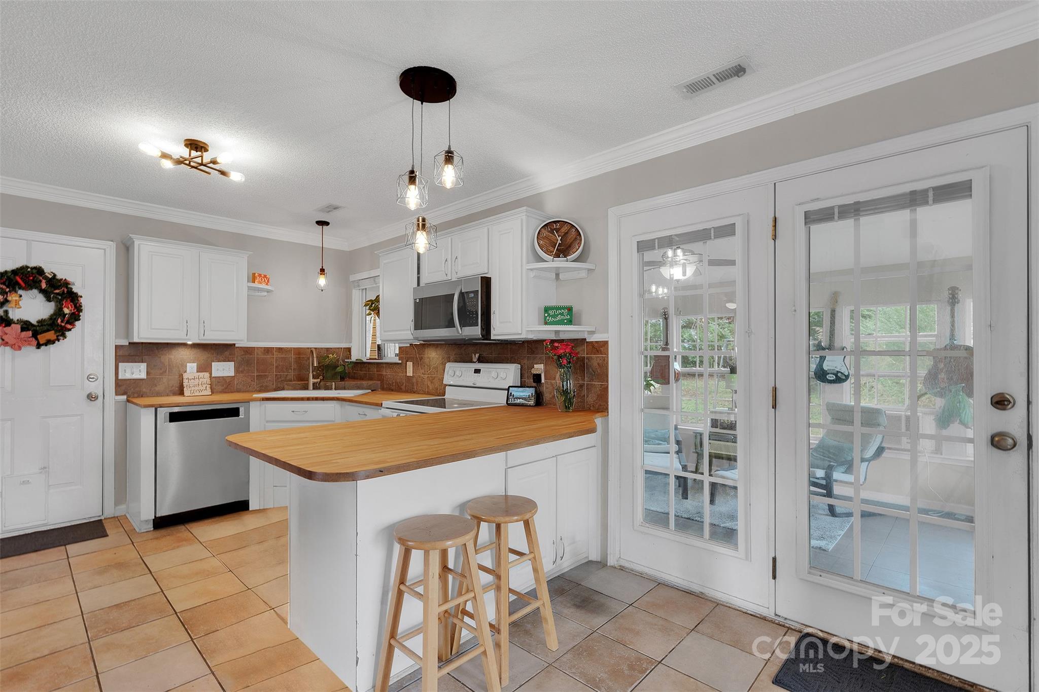 3007 Wyntree Court Matthews, NC 28104 - Photo 7 of 44 a kitchen with stainless steel appliances a sink a stove a refrigerator cabinets and dining table