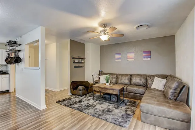 a living room with furniture and wooden floor