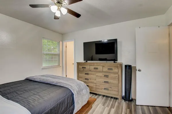 a bedroom with a bed and flat screen tv
