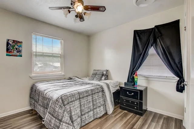 a bedroom with a bed and wooden floor