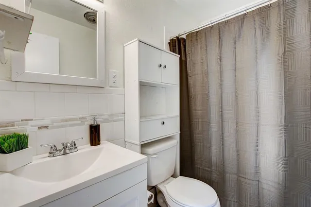a bathroom with a sink toilet and tub