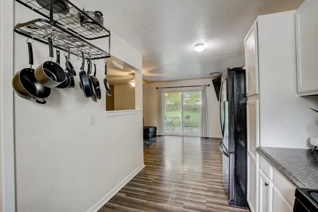 a hallway with a hardwood floor and a view of hallway