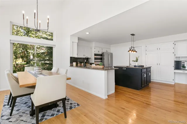 a view of kitchen with stainless steel appliances granite countertop cabinets and wooden floor