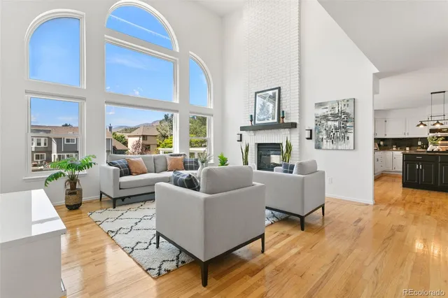 a living room with furniture fireplace and a table