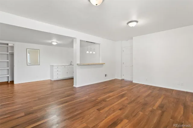 a view of a kitchen with wooden floor and a sink